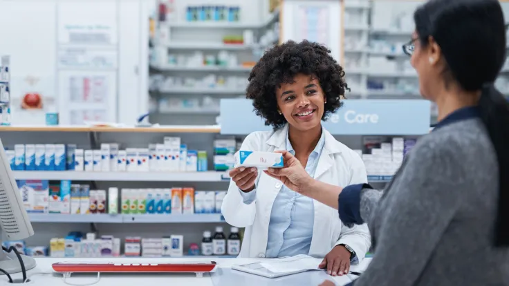 Pharmacist assisting a customer in a pharmacy