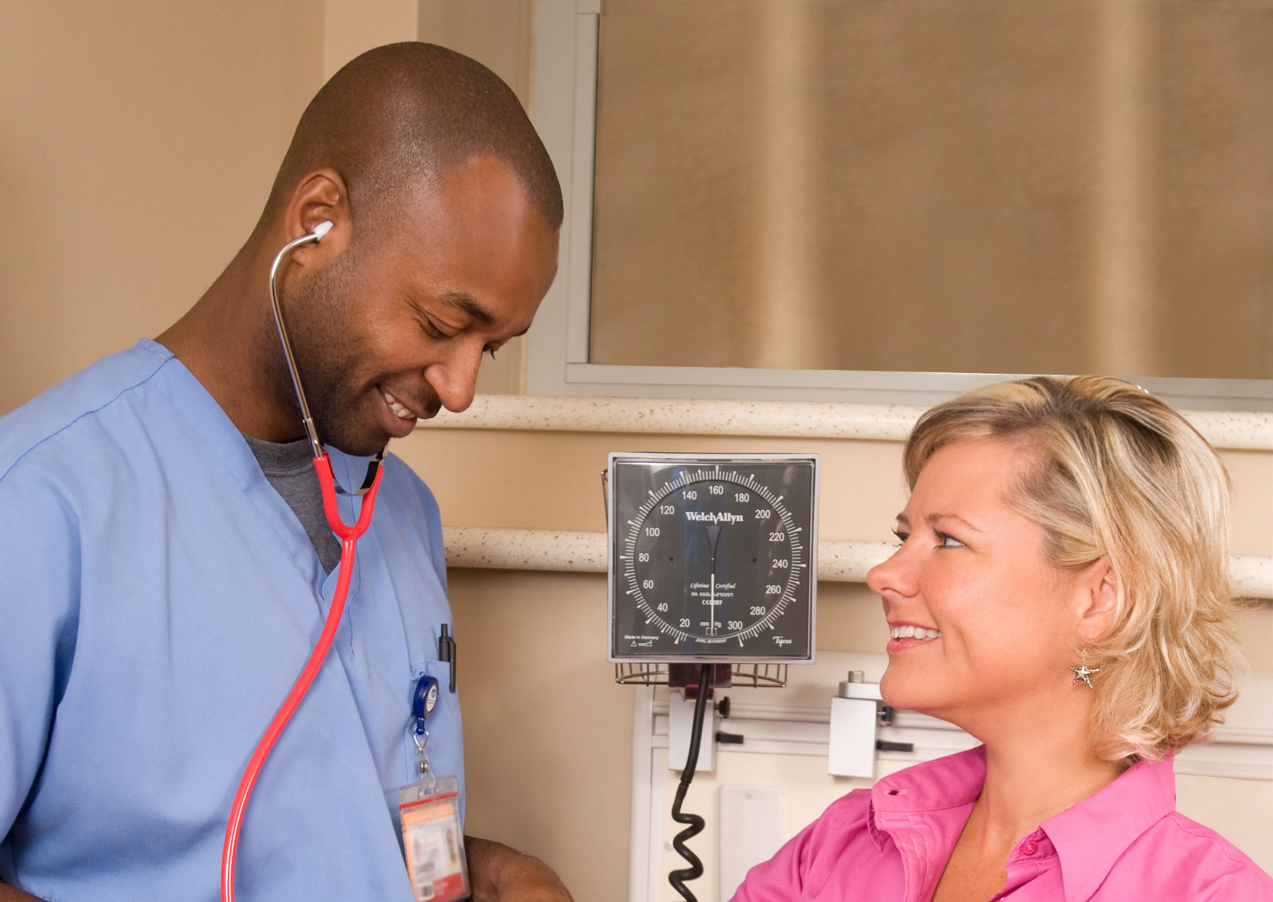 male nurse taking female patient blood pressure
