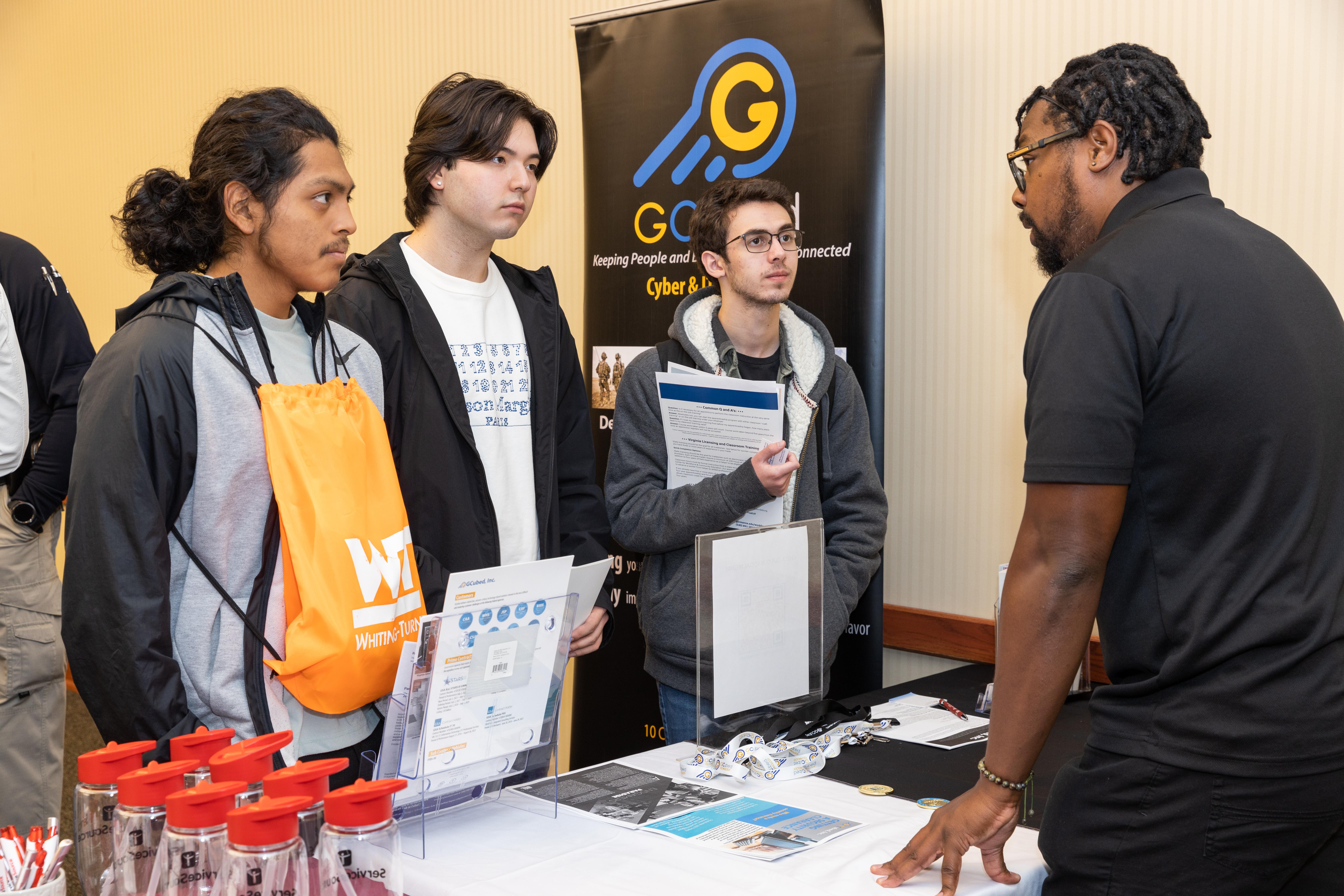 A group of students hear from a career coach at a career fair