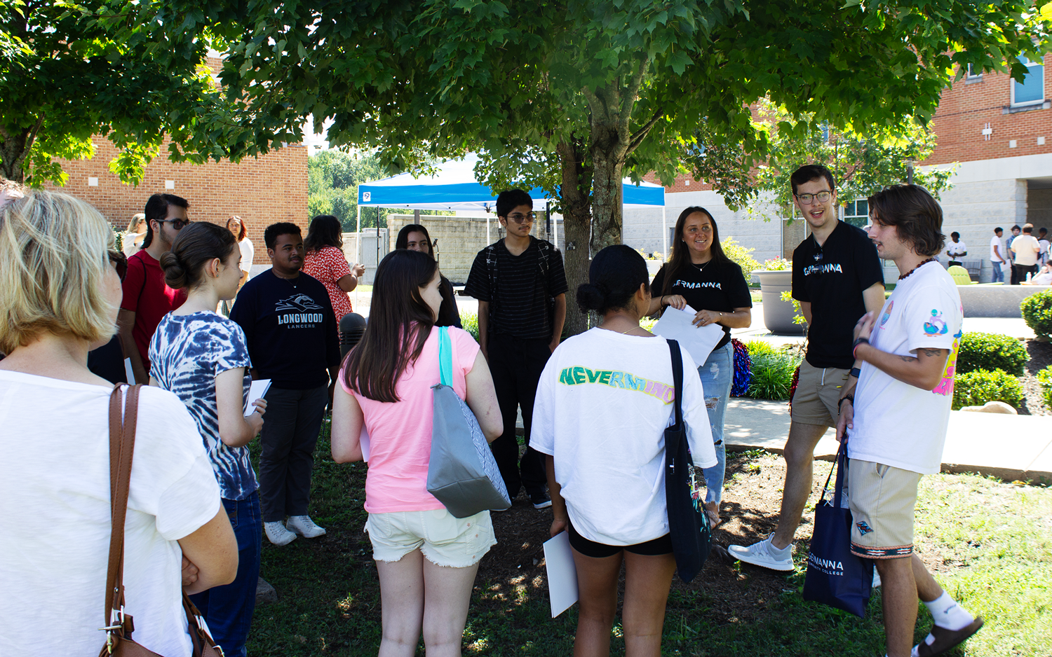 Students listen to an open house tour guide speaking