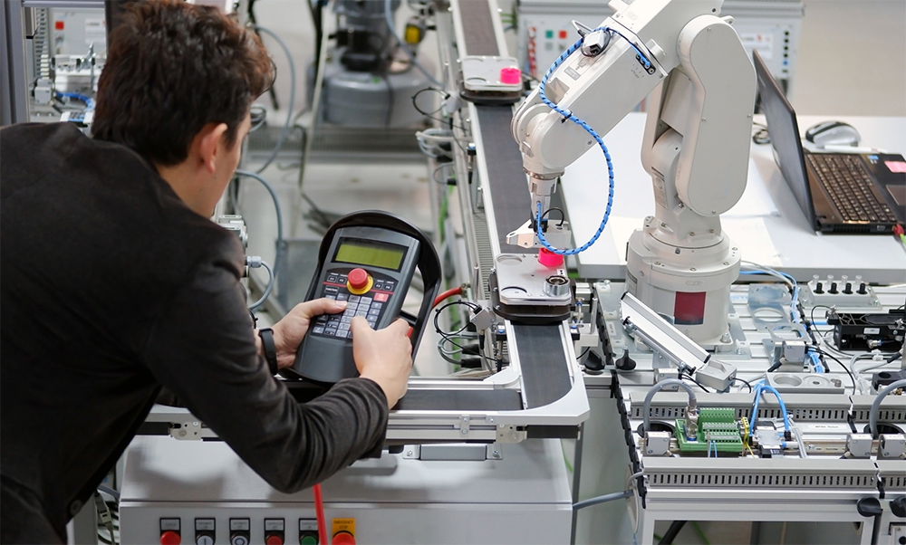 A student works with a robot in a laboratory