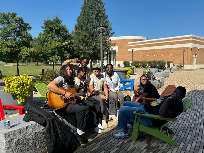 Timothy (far left) shown with some of his friends and club members on the Fredericksburg Area Campus quad