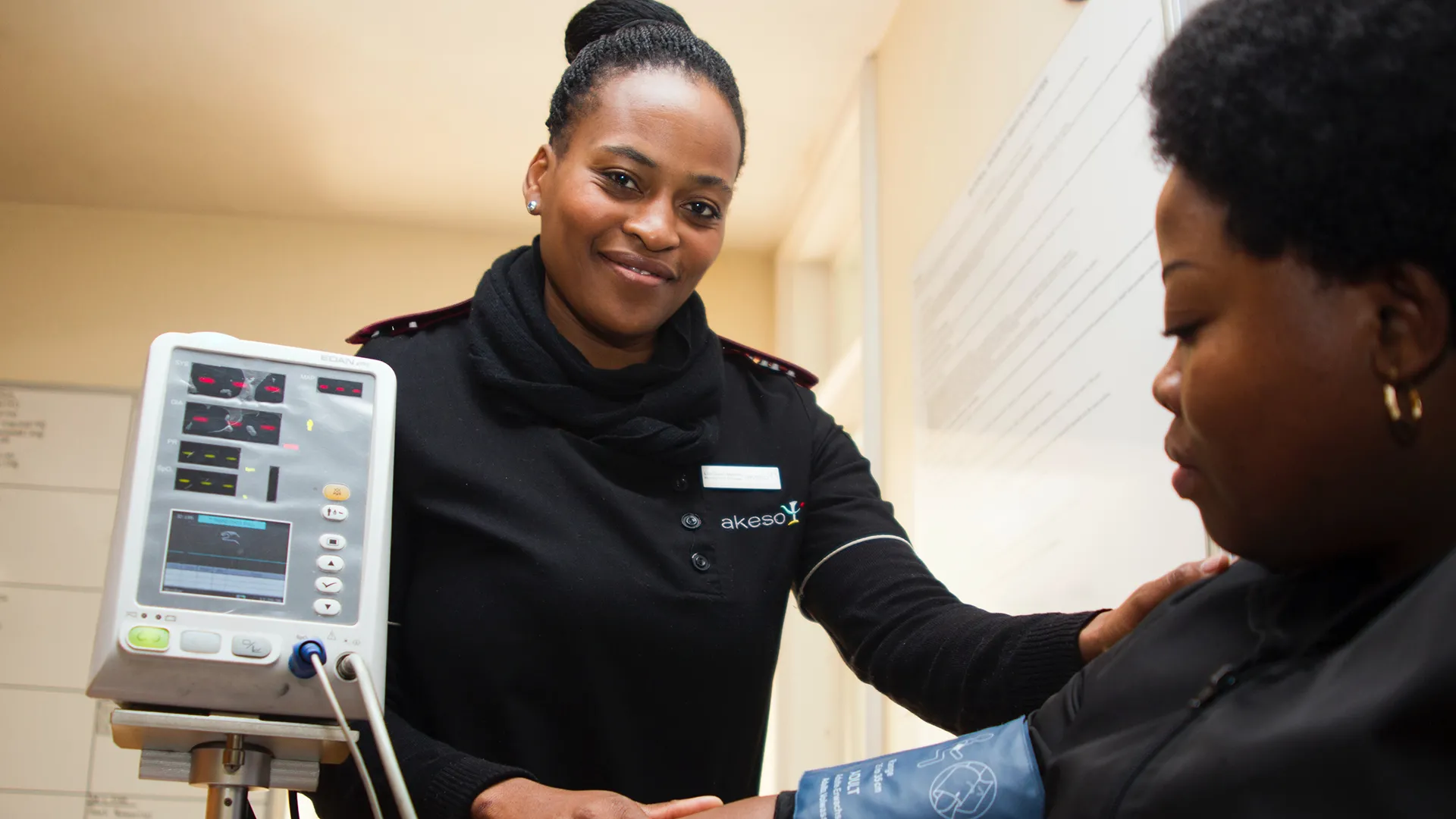 African American nurse taking blood pressure
