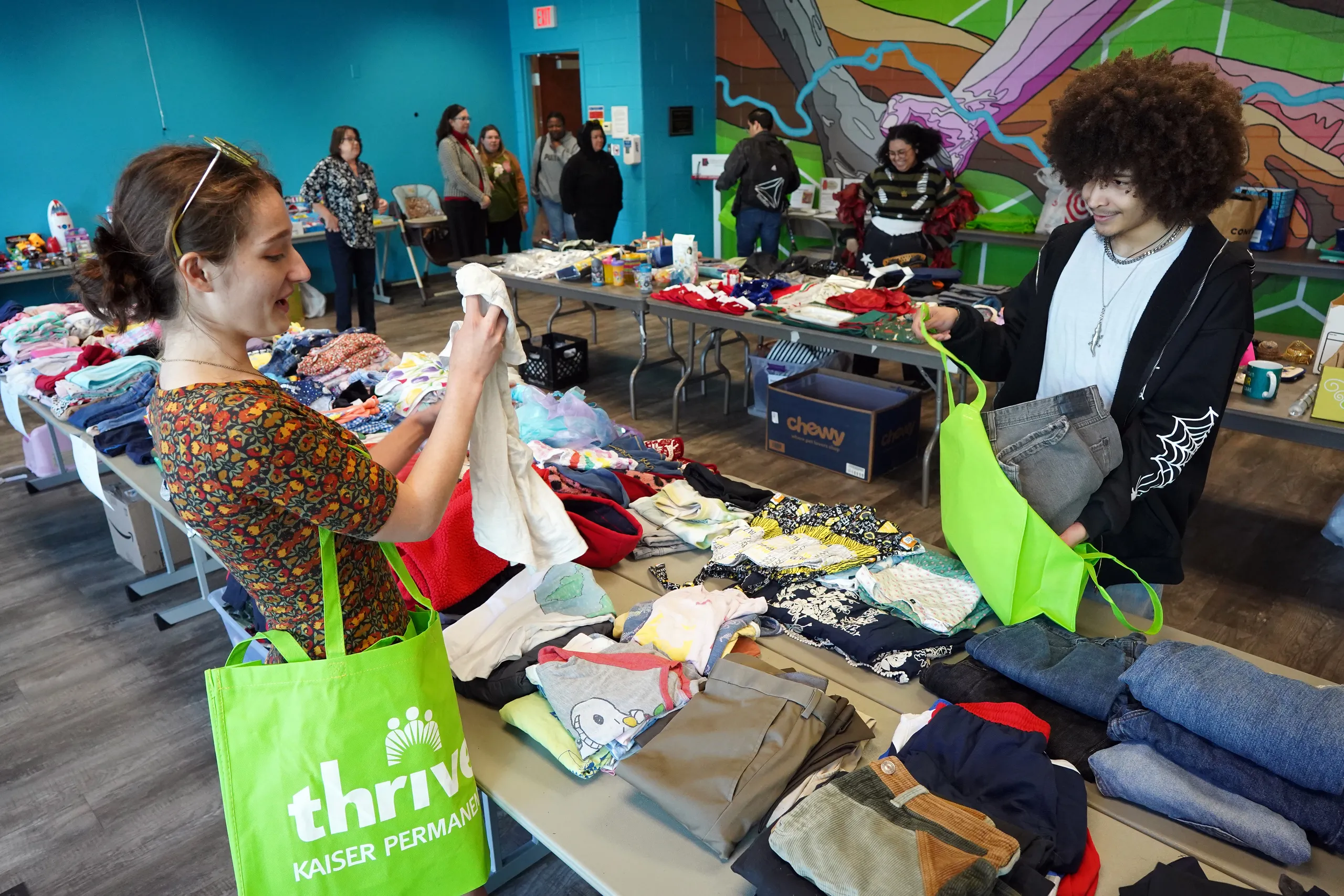 Two students look through clothing at Shop Day