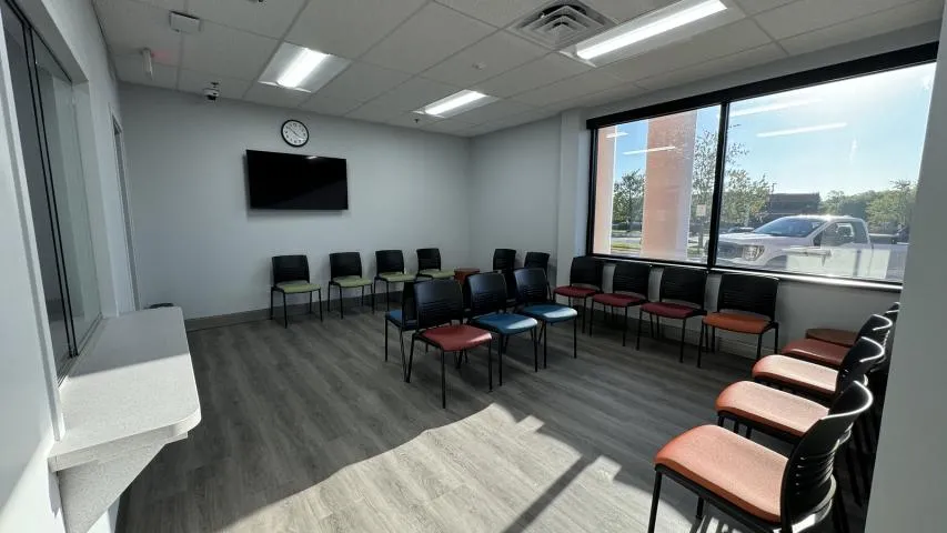 Several chairs arranged in a waiting room or reception area of a clinic