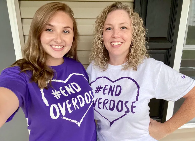 Anita Newhouse (right) with a student promoting Overdose Awareness Day