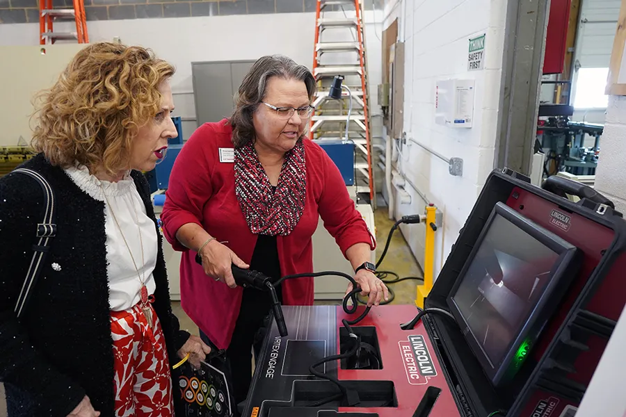 Tina Lance, dean of business and workforce development (right), shown with Wendy Zelazny, senior vice president of membership & strategic growth of the Fredericksburg Regional Chamber of Commerce, as they explore one of the electrical simulation machines [Credit: Suzanne Rossi]