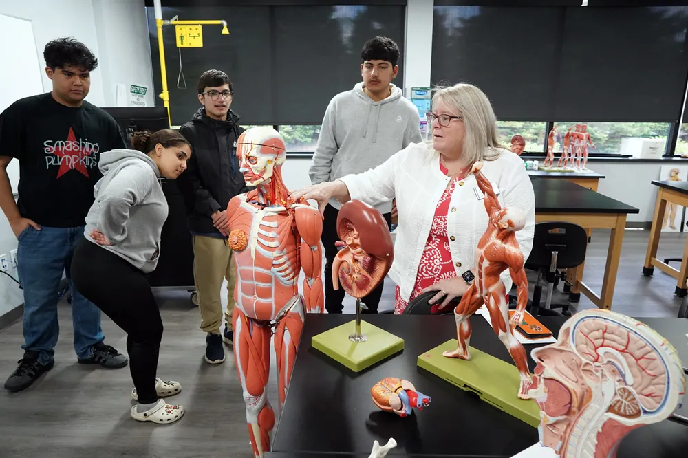 Professor Kobersteen (right) showing students an anatomy model