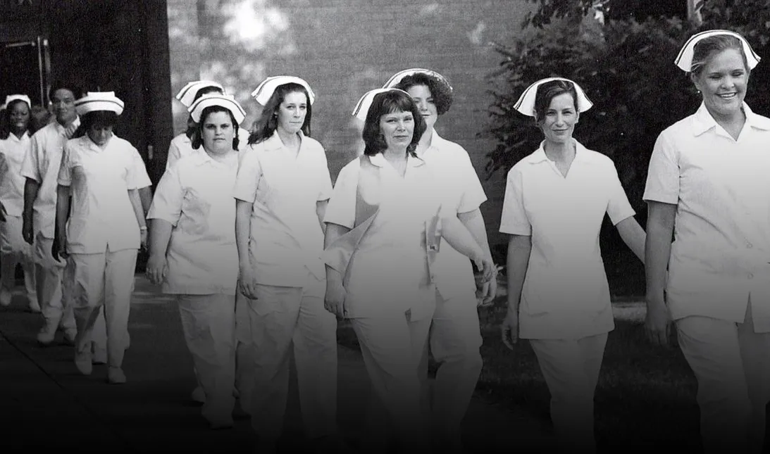 Black and white archival photo of past Germanna nursing students walking at graduation
