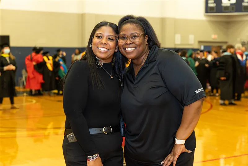 Professor Hayes (left) shown with her sister Jaleesa Hayes, Administrative Assistant to the Dean of Science and Technology, at the 2022 Fall Commencement