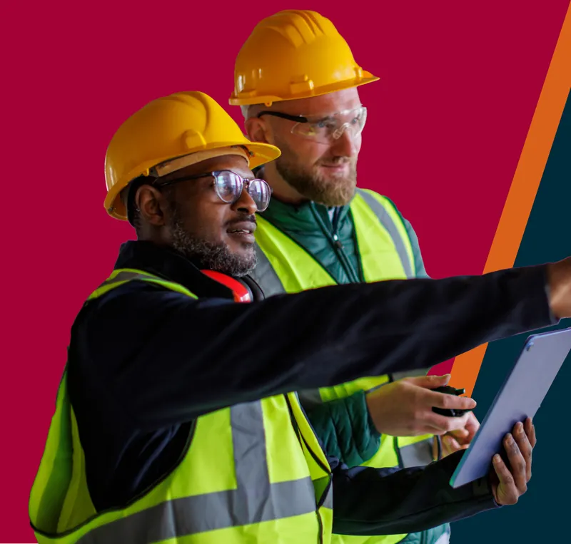 Two construction workers discuss work on a job site