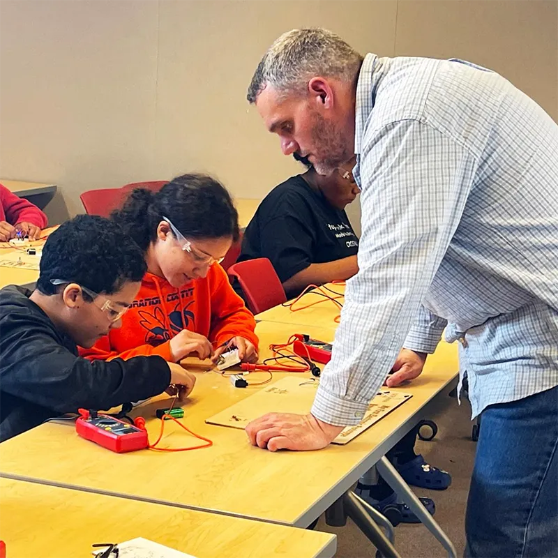 Dr. Harry Schoeller (right) shown interacting with local high school students at a Germanna Makerspace workshop