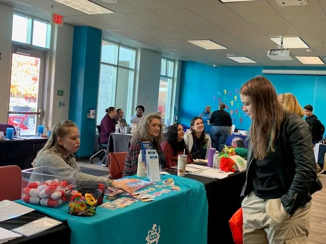 A student engaging with a local community resource at the 2024 Resource Fair
