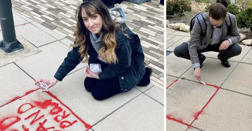 Participants pour red sand into sidewalk cracks as part of the Red Sand Project, an art initiative designed to raise awareness of human trafficking