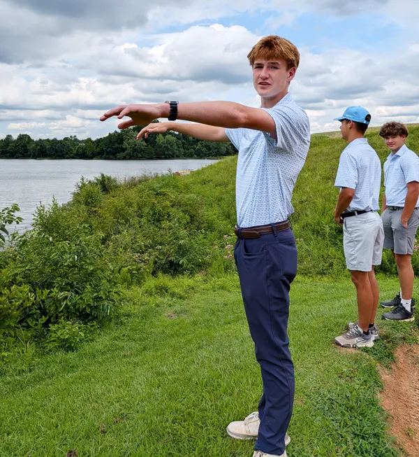 Gavin Cain points to a place about 50 yards from the shore of Lake Culpeper Lake where he and fellow Germanna Scholar Jackson Castro and friend Andrew Tuggle, 15, rescued a family in distress. The three were at Culpeper Country Club to try out for the Eastern View High School golf team when they saw three people struggling in the water.