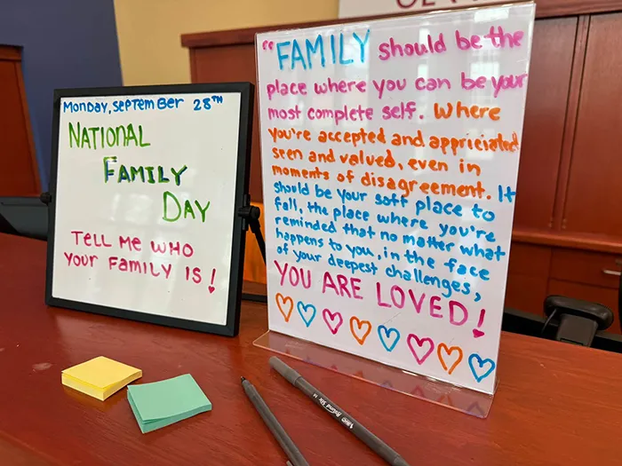 Signs on the front desk in the lobby telling students about National Family Day