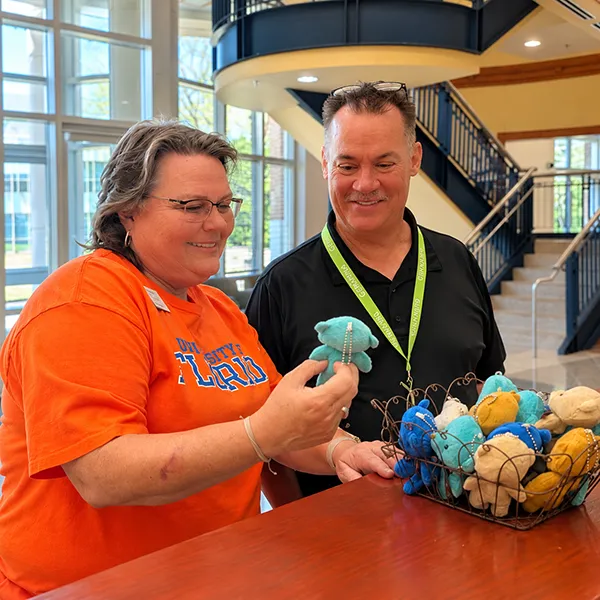 Dean of Professional and Technical Studies and Workforce Development Tina Lance looks at tiny teddy bears with HVAC instructor Mike Beachy.