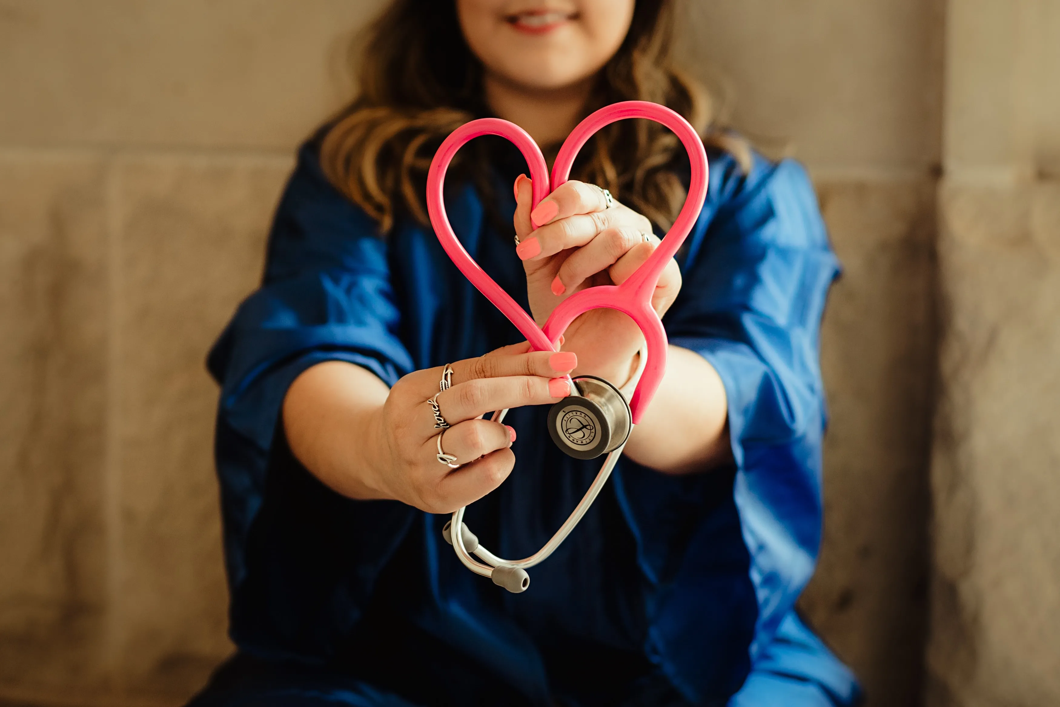 Nurse Holding stethoscope formed into a heart shape