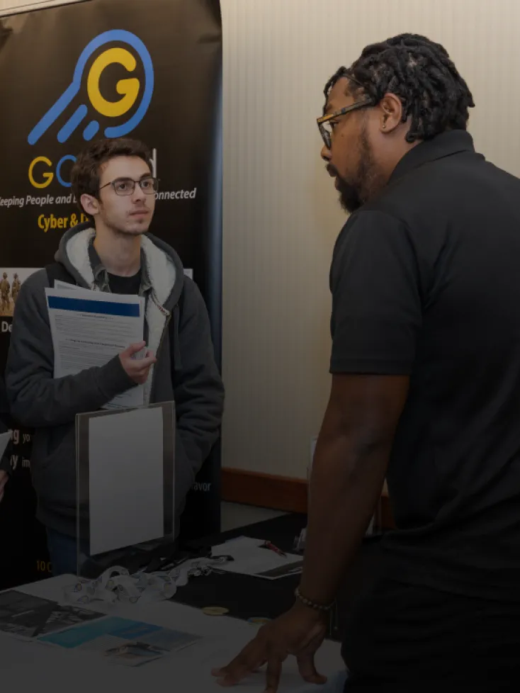 Students listen to a staff member at the career fair