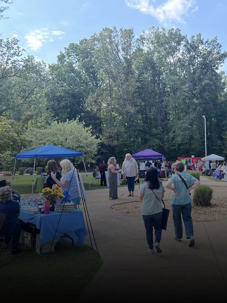 Prospective students and Germanna staff mill around outdoor tables during the Health Sciences Fall Festival