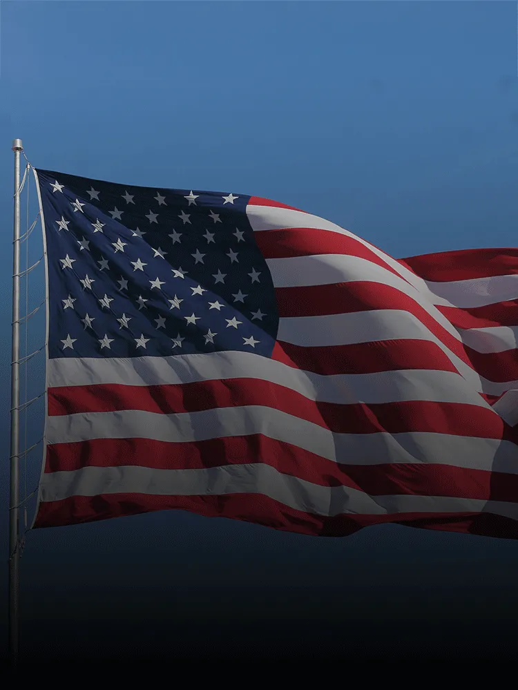 The US flag waving from a flagpole