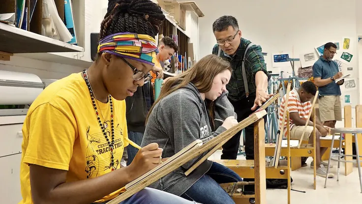 Germanna students working with a faculty on an art project