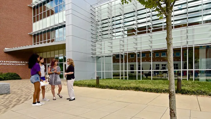 Group of students standing outside the Science and Engineering Building at the Fredericksburg Area Campus