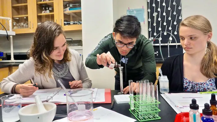 High school dual enrollment students learning in a chemistry lab