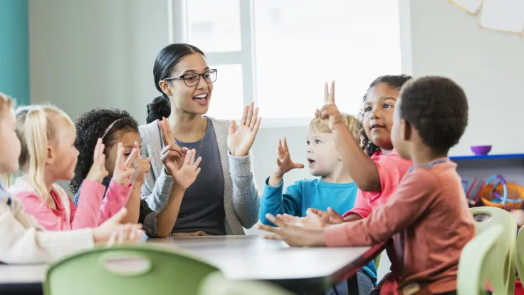 Young African American teacher with K-8 students
