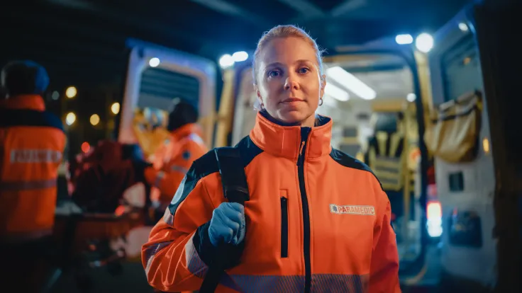 Paramedic team working next to an ambulance 