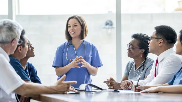 A multi-ethnic group of medical staff are indoors in a hospital