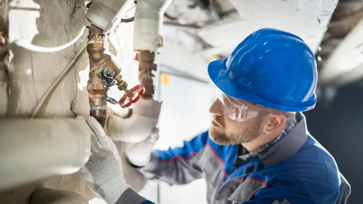 Plumber working on copper pipes