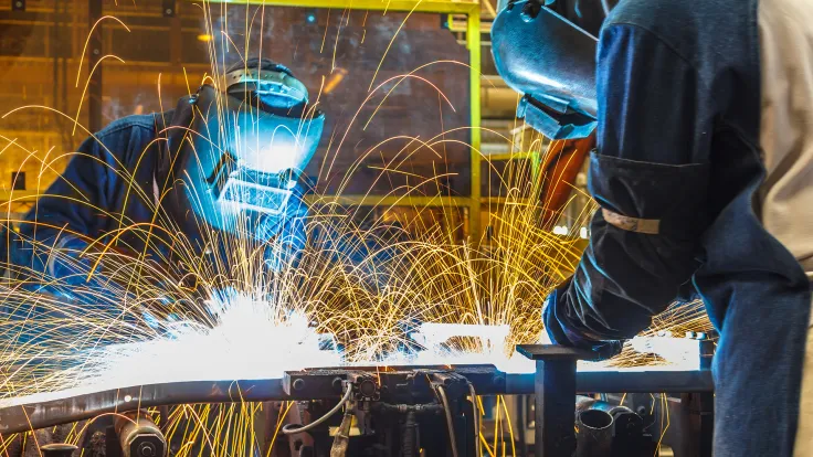 Two people welding