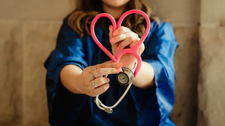 Nurse Holding stethoscope formed into a heart shape