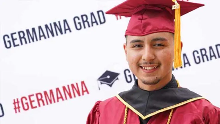 Germanna graduate wearing a cap and gown