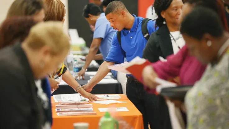 A man perusing brochures on a table at a wellness fair