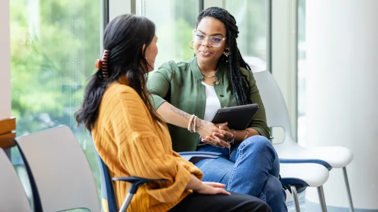 A Behavioral Health Technician listens while a patient speaks
