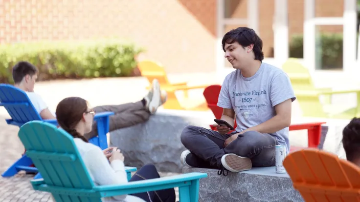 Students relax in the summer weather on campus