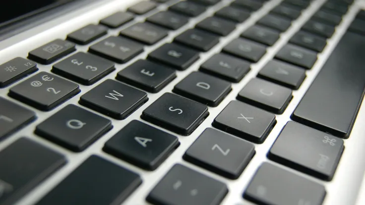Closeup photo of a Macbook keyboard [credit: Disk Depot Ltd. on Wikimedia Commons'