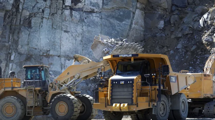 Large construction machinery in operation at a stone quarry