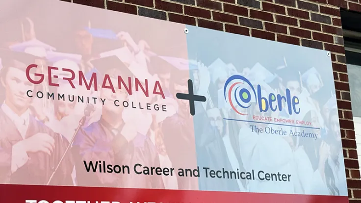 Sign on a brick building reading "Germanna Community College + Oberle Academy"