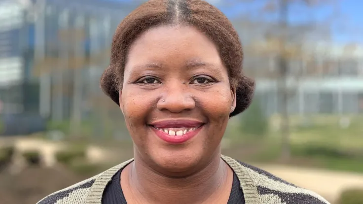 Headshot of Stacy Washington in the foreground with the Science & Technology building in the background.